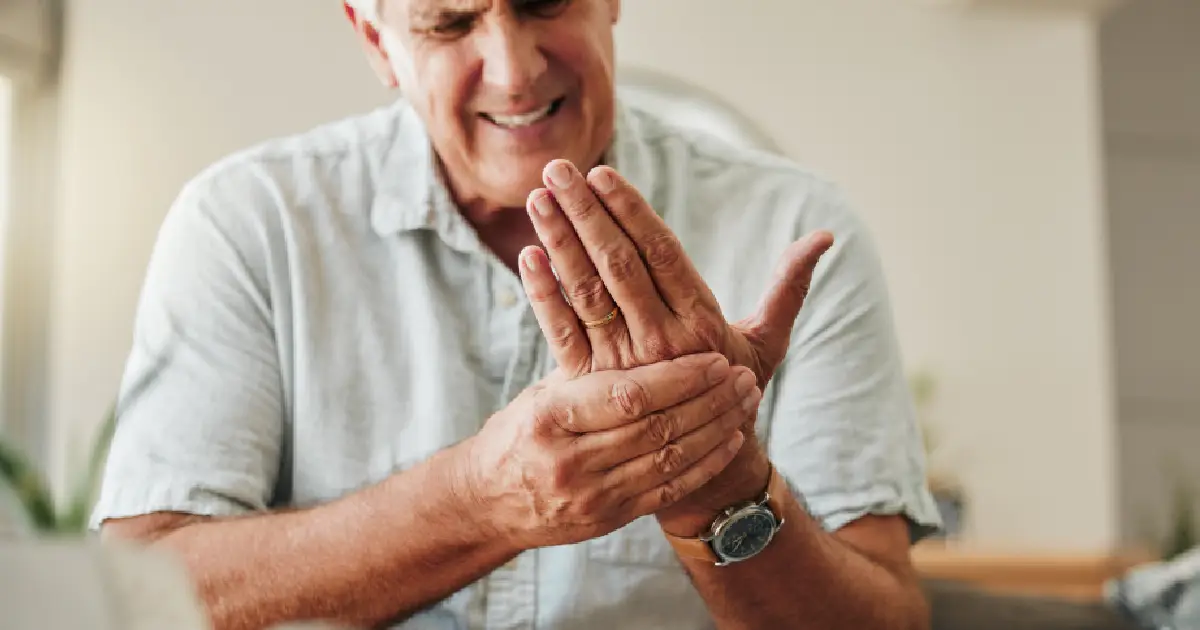 Older man holding his hand due to fibromyalgia in Princeton, WV