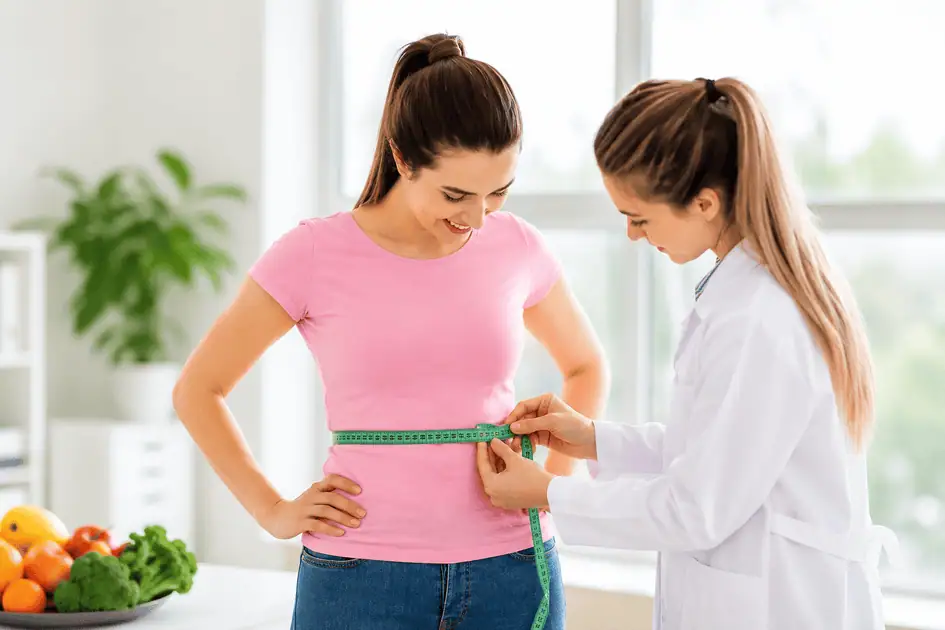 Woman having her waist measured during a physician-supervised weight loss program
